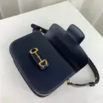 the bag comes with a small pouch containing two button covers that can be used to conceal the exposed studs when the shoulder strap is lengthened.The bag offers practicality with its functional design. It features a Horsebit detail at the front and half Horsebit details on each side. The interior is divided into three gussets
