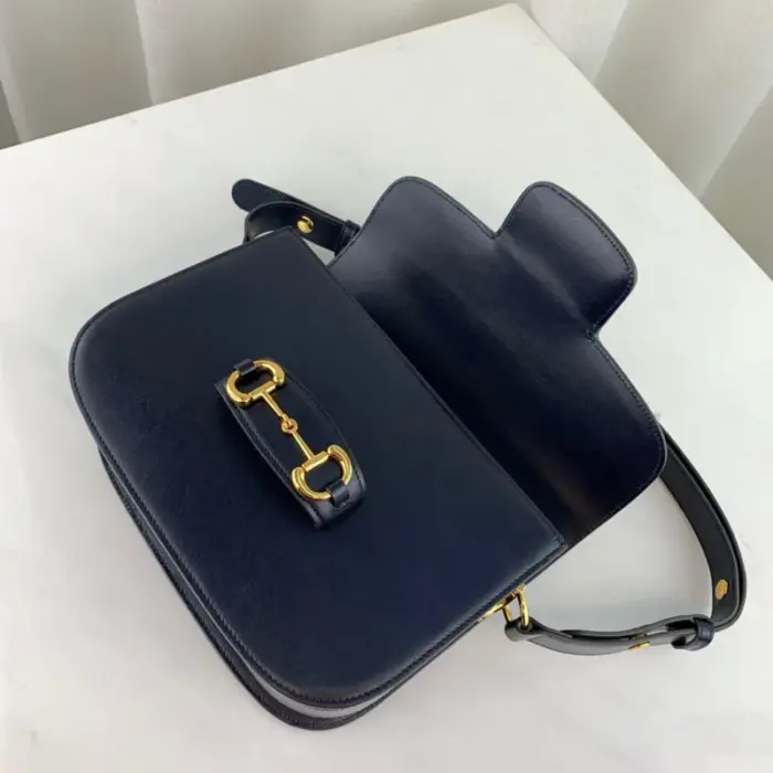 the bag comes with a small pouch containing two button covers that can be used to conceal the exposed studs when the shoulder strap is lengthened.The bag offers practicality with its functional design. It features a Horsebit detail at the front and half Horsebit details on each side. The interior is divided into three gussets