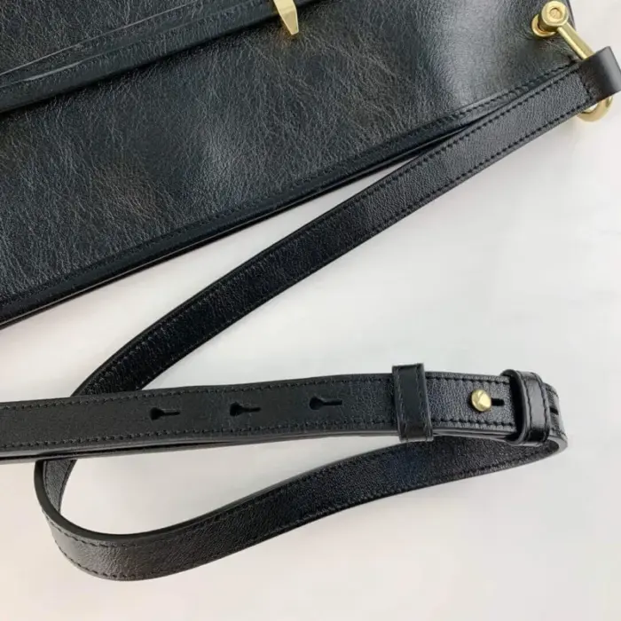 adding a touch of opulence. This harmonious combination of black leather and gold accents creates a visually striking contrast.The interior is lined with microfiber