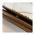 adding a touch of sophistication. The gold-toned hardware further elevates the overall look.Inside