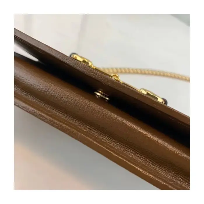 adding a touch of sophistication. The gold-toned hardware further elevates the overall look.Inside