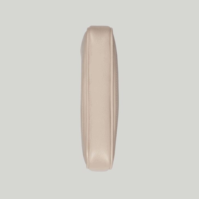 it's presented in a soft white leather with a gold-toned zip closure.