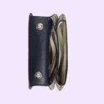 enriching the design with a timeless feel—mirroring the Hollywood glamour that shaped the fashion show. The top handle bag is completed by two interchangeable straps