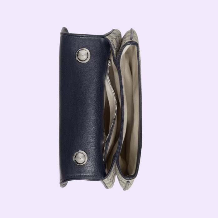 enriching the design with a timeless feel—mirroring the Hollywood glamour that shaped the fashion show. The top handle bag is completed by two interchangeable straps