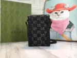 highlighting its connection to Gucci’s rich history. The bag is finished with a sleek black leather trim and signature gold-toned hardware.Made from black and ivory GG denim jacquard