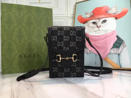 The Gucci Double G Horsebit 1955 Mini Bag is a luxurious accessory that combines the classic elements of Gucci’s heritage with a modern twist. Crafted from black GG denim
