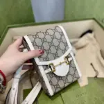 which has become synonymous with the Gucci brand.Crafted from beige and ebony GG supreme canvas