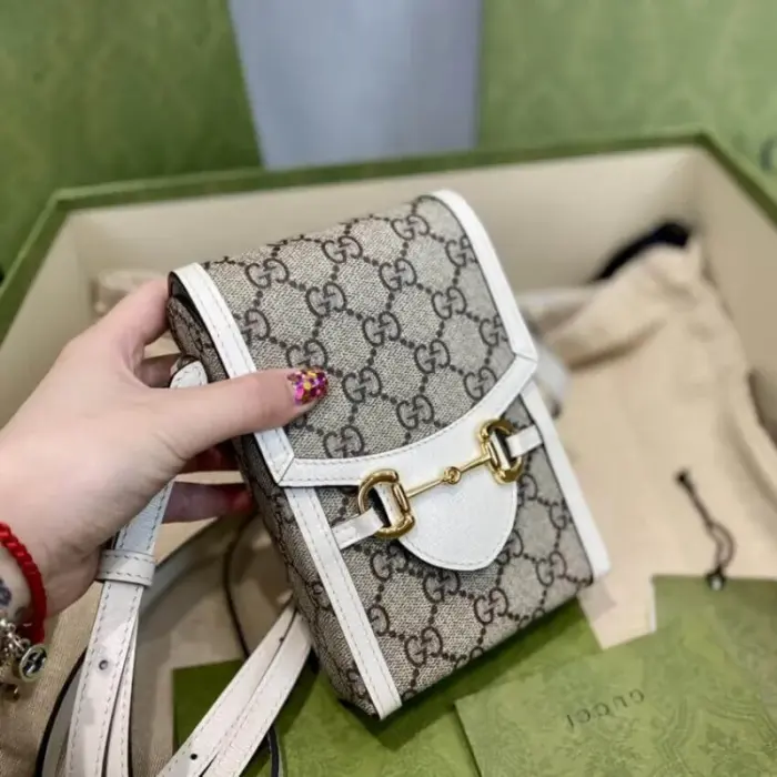which has become synonymous with the Gucci brand.Crafted from beige and ebony GG supreme canvas