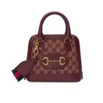 The Gucci Horsebit 1955 GG Mini Bag in Burgundy GG Canvas is a must-have accessory that effortlessly combines timeless style with modern practicality.With dimensions of 20 x 19.5 x 7.5 cm