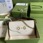 offering two detachable shoulder straps for multiple styling options. One strap showcases the iconic green and red Web design