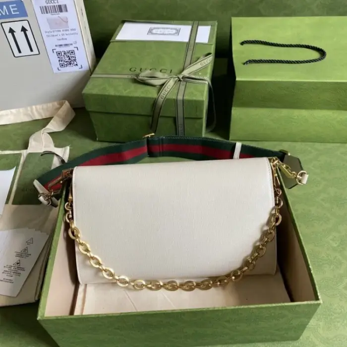 while the other features Gucci’s recognizable gold-toned chain design.Crafted from premium black leather