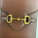 which pays homage to the equestrian world and has become synonymous with the brand.The bag features gold-toned hardware