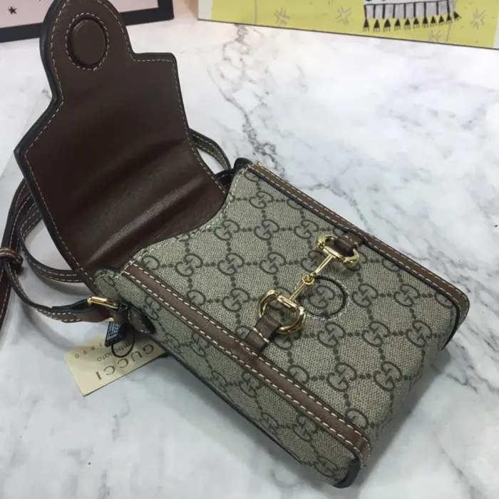 this mini bag features a microfiber lining with a suede finish. It includes a horsebit detail