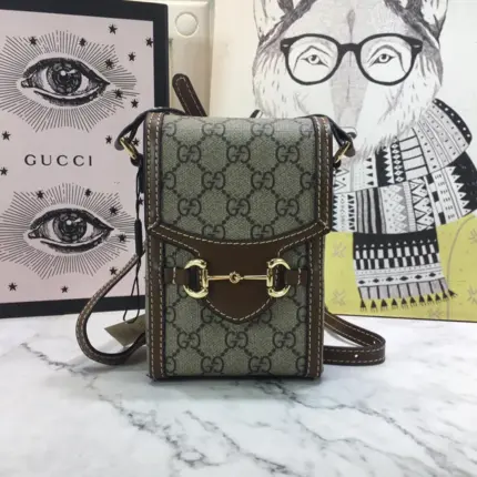 The Gucci Horsebit 1955 Mini Bag 625615 is a captivating accessory crafted in Italy. Made from the iconic beige and ebony GG supreme canvas