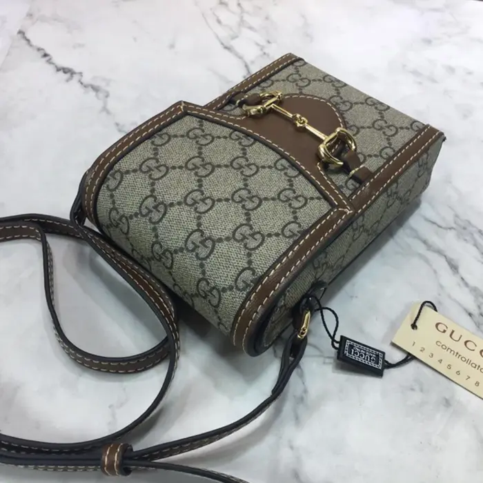 it can comfortably accommodate a cell phone measuring up to 3.1??W x 6.3??H x .3??D. The adjustable leather strap with a drop of 19.7?? provides versatility in styling and wearing options.The magnetic flap closure ensures the security of your belongings while adding a touch of effortless sophistication. Every detail of this mini bag is meticulously crafted