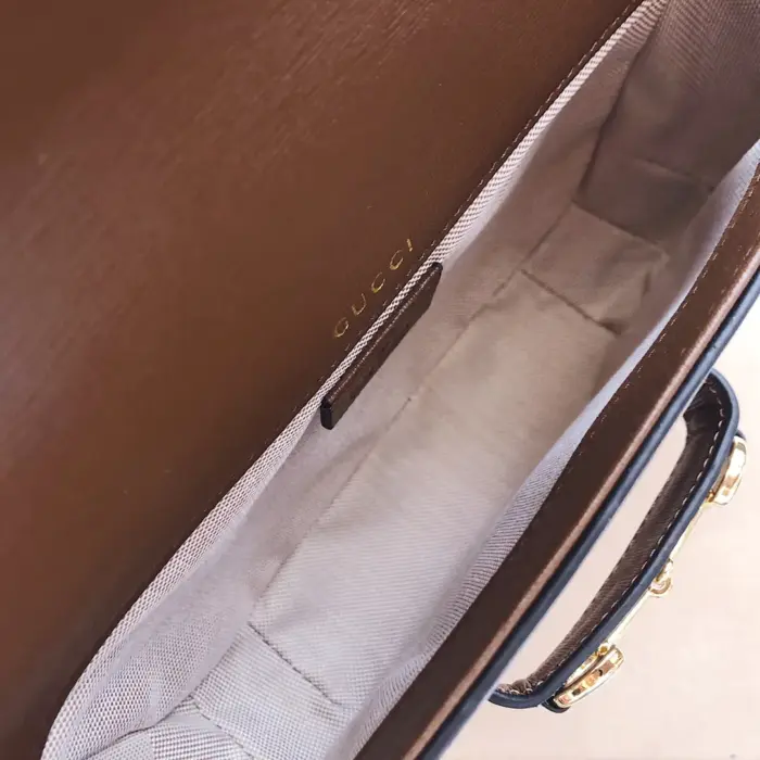 making it ideal for on-the-go essentials. The bag features gold-toned hardware and a distinctive Horsebit detail