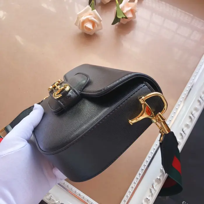 adding a pop of color and a strong logo feel. The tonal leather strap gives the bag an understated elegance