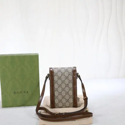 a stunning accessory presented in a petite rectangular shape. This exquisite bag features the iconic Gucci monogram canvas