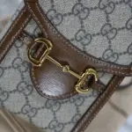 this bag pays homage to the equestrian world with its double ring and bar embellishments