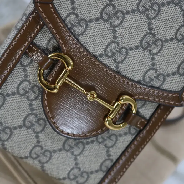 this bag pays homage to the equestrian world with its double ring and bar embellishments