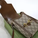 a symbol that has become synonymous with the brand.Crafted from beige and ebony GG supreme canvas