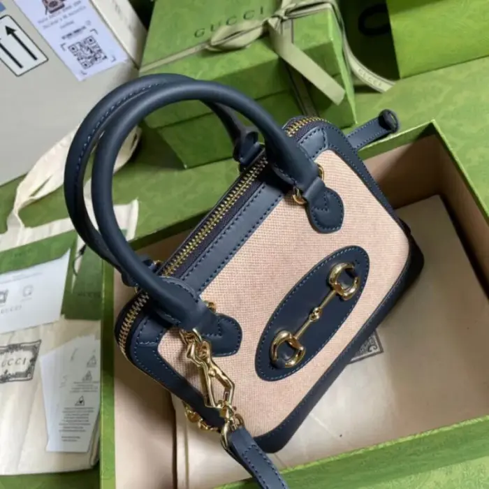 this mini top handle bag can comfortably accommodate a cell phone measuring up to 3.1??W x 6.6??H x .4??D. To further enhance its versatility