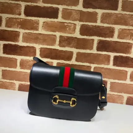 The Gucci Horsebit 1955 Python Small Shoulder Bag 602204 Black is an exquisite piece from the Beloved family that pays homage to the rich history of the Gucci House. This stunning shoulder bag is a recreation of an archival design