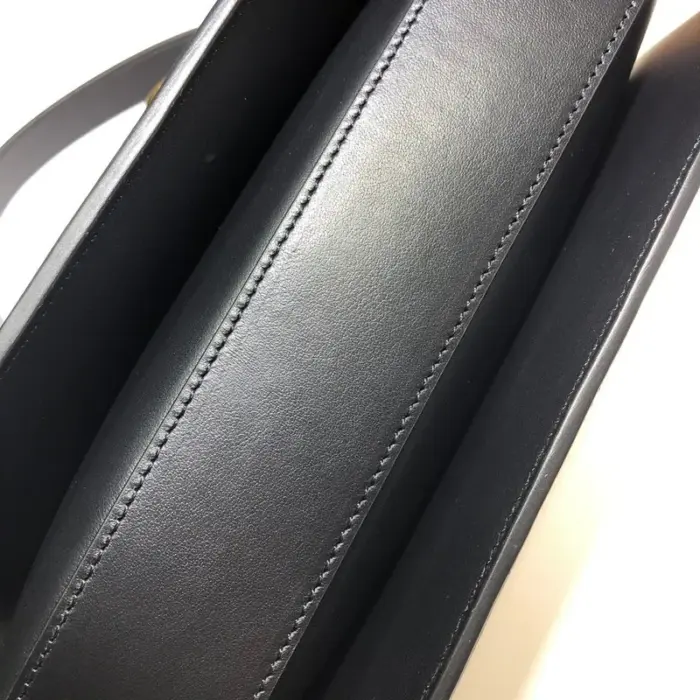 each bag comes with a small pouch containing two button covers that can be used to conceal the studs when the shoulder strap is lengthened. The bag’s interior boasts three gussets