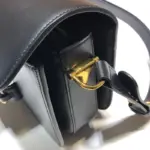 including one zipper pocket and one open pocket. The shoulder strap