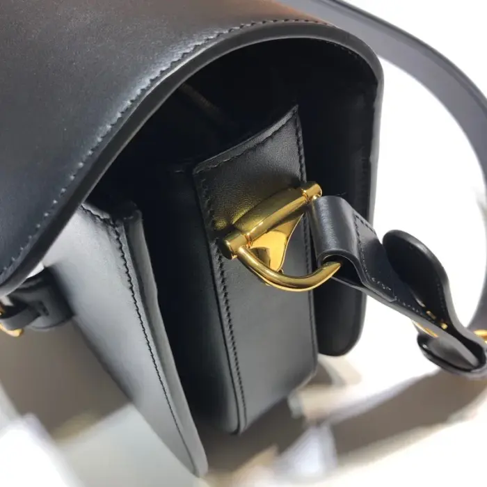 including one zipper pocket and one open pocket. The shoulder strap