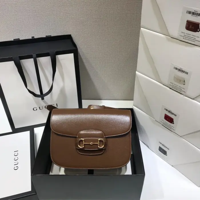 the Gucci Horsebit 1955 shoulder bag features a flap closure for easy access and weighs approximately .84kg