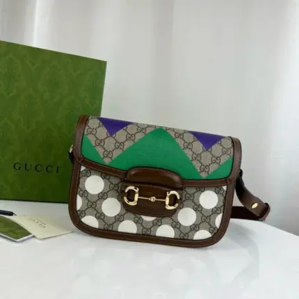 a fashionable accessory that showcases bright and colorful geometric motifs reminiscent of horse riding jockey uniforms. This stunning design is inspired by the Parade Ring