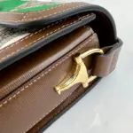 it radiates both style and sustainability. The bag is adorned with brown leather trim and shiny gold-toned hardware