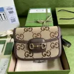The Gucci Horsebit 1955 Shoulder Bag With Jumbo GG 602204 is a stunning bag that channels the iconic design of Gucci. Its dimensions are 9.8 inches in width