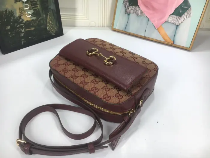 there is a front pocket for extra storage space. The bag can easily accommodate a cell phone up to 3.1??W x 6.6??H x .4??D.The shoulder strap has a 19.7″ drop