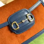 the shoulder strap is adjustable with snap buttons