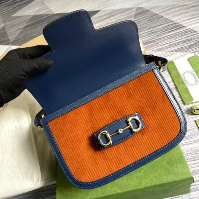 containing two additional button covers that can be used to elegantly conceal the exposed studs when the shoulder strap is lengthened. The bag is further secured with a flap closure