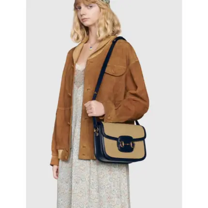 a modern interpretation of a classic archival design. Crafted from beige vintage canvas with a blue leather trim