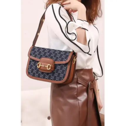 Introducing the stunning Gucci Horsebit 1955 Small Bag in Blue Denim. This stylish bag measures 9.8 inches in width