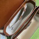 each bag comes with a small pouch that contains two extra button covers. These covers can be used to hide the exposed studs when the shoulder strap is lengthened