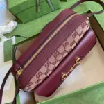 accentuated by luxurious burgundy leather trim. The gold-toned hardware adds a touch of glamour and sophistication.The Horsebit detail adorns the front of the bag