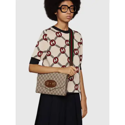 and the other in Gucci’s recognizable gold-toned chain design. Crafted from GG Supreme canvas