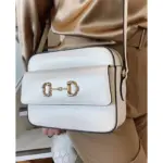 this bag features a double ring and bar detail that represents the brand’s heritage.Made from high-quality brown textured leather