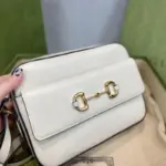 and 2.6 inches in depth.The bag is adorned with gold-toned hardware