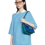 a stunning piece from the iconic Gucci collection. This bag features the signature Horsebit hardware that the brand is known for