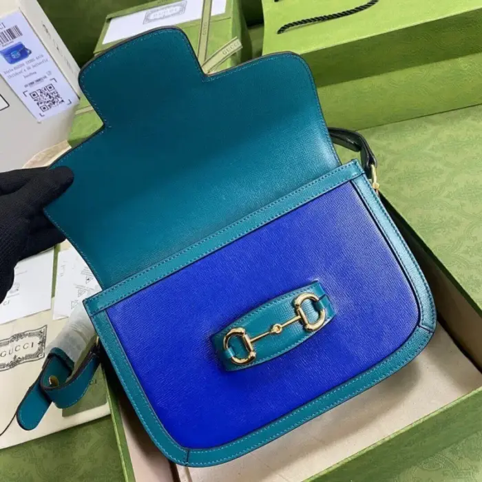 this bag is made with blue leather and features exquisite turquoise leather trim. The gold-toned hardware adds a touch of elegance to the design