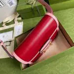 while half Horsebit details can be found on each side.One unique feature of this bag is the inclusion of a small pouch with two additional button covers. When the shoulder strap is lengthened