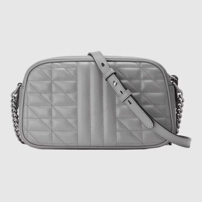 the style is reimagined with a new geometric approach to the signature material while its Double G hardware is presented with an antique silver-toned finish. The design appears here in the shape of a small shoulder bag in dark grey.