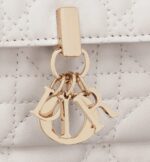 it is embellished with a 'D.I.O.R.' charm for a chic and timeless allure. Thanks to its numerous compartments