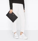 the design is embellished with hallmark Cannage topstitching and a 'CD' signature on the front. The large pouch can hold all the essentials